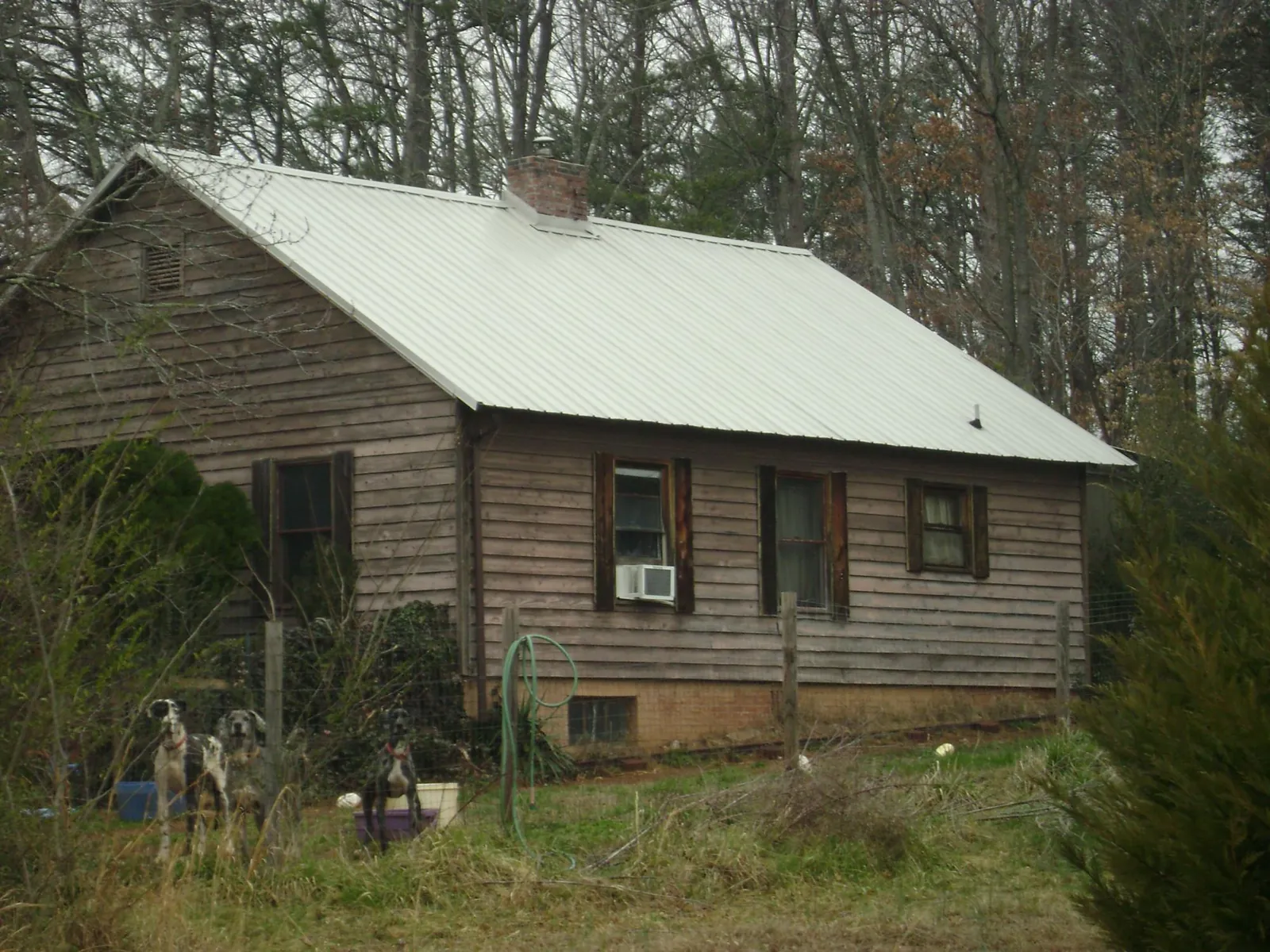 White metal roof on an old wood sided farmhouse, from a Asphalt Shingle Roof Repair job in Manville